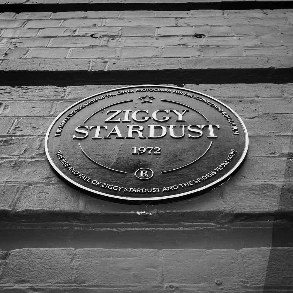 Plaque with 'Ziggy Stardust' text on a brick wall heddon street